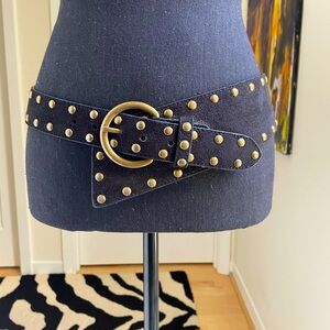 A symmetrical brass studded, faux suede belt, brass buckle with 5 hole options.